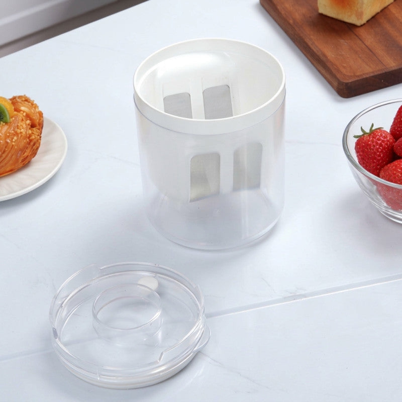 Clear plastic container on a kitchen counter with food items in the background